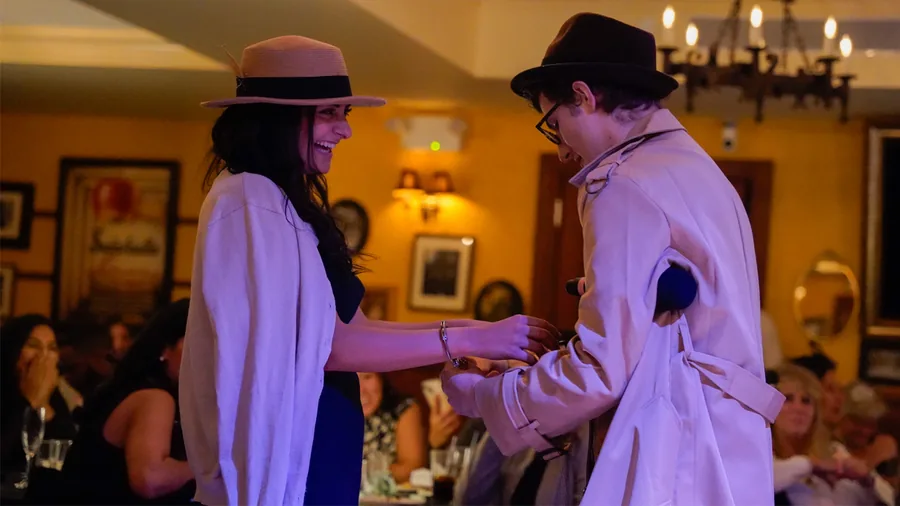 A Murder Mystery Company detective questioning a guest at a Seattle show